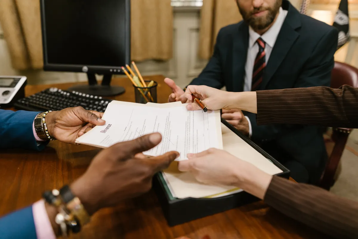 Adults review documents together at an office table.